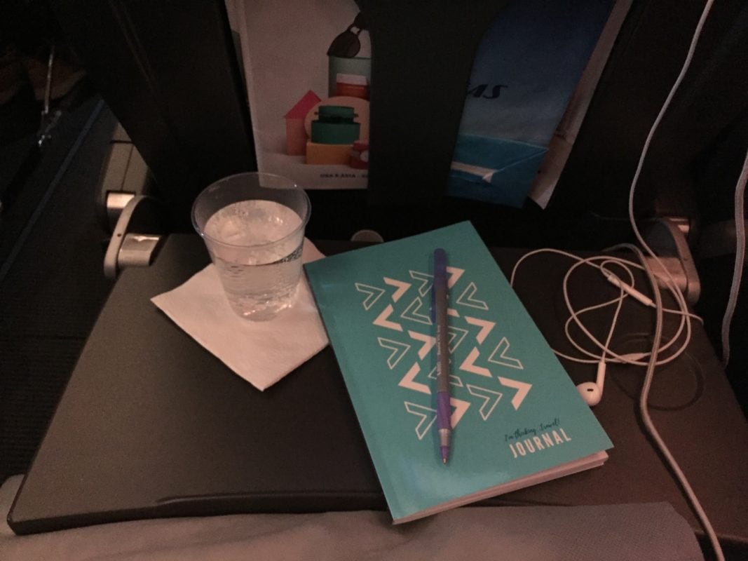 journal, headphones and water