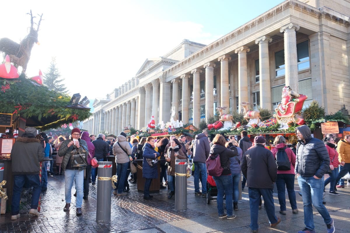 People enjoying sunny day at Christmas market