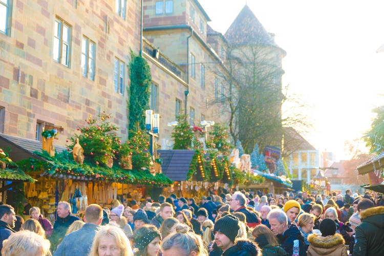 crowded Christmas market booths during the daytime
