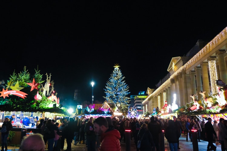 People enjoying the market and lights at night