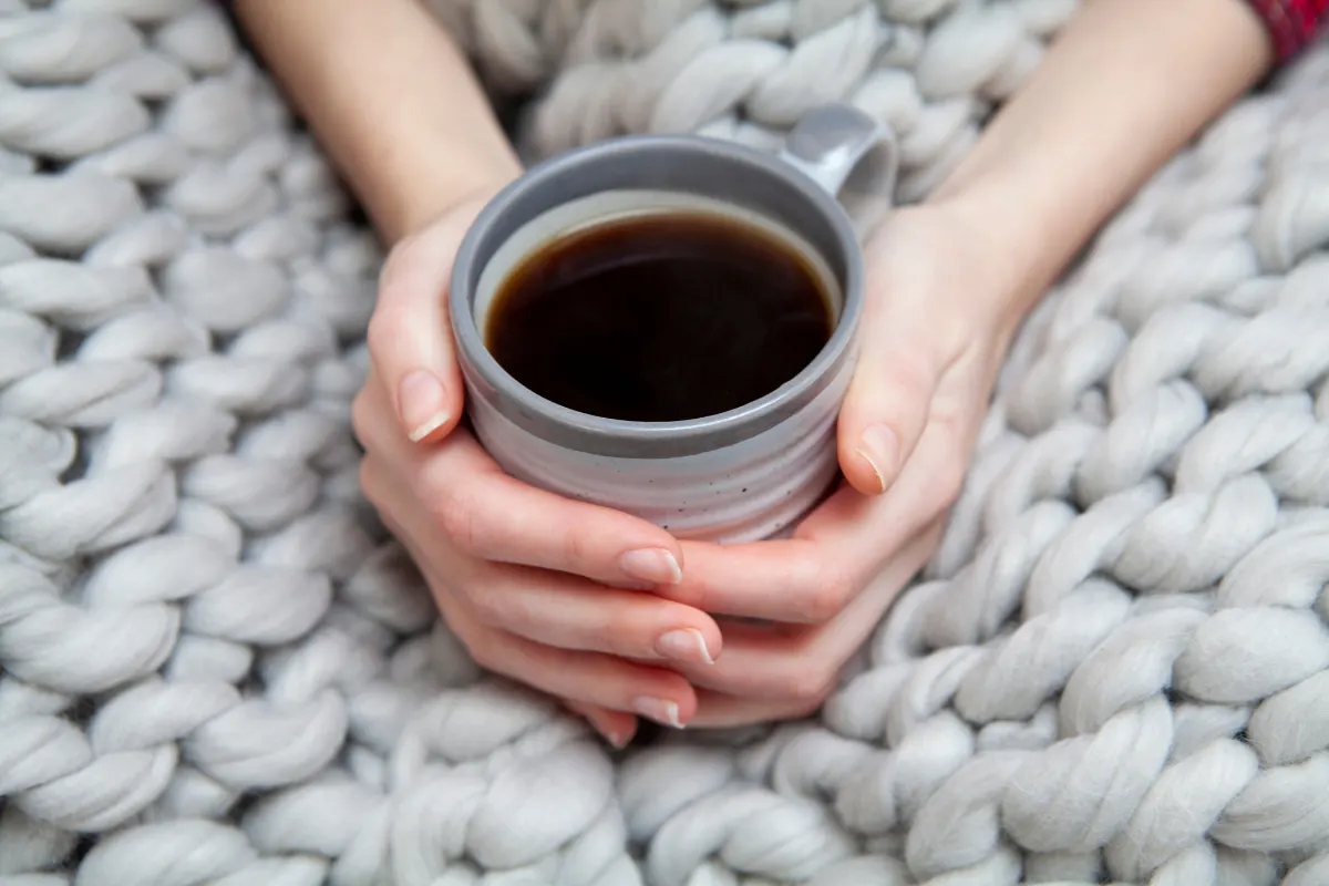 holding a hot cup of tea