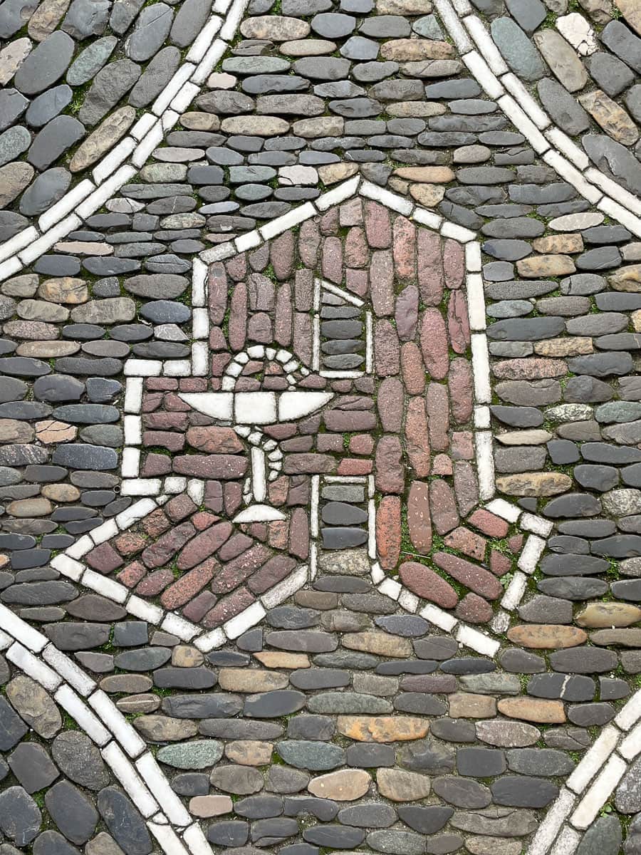 Pharmacy sign make of stones in the sidewalk